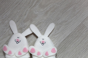 Cute creative Easter background, texture with easter bunny toys on wooden background; egg warmer