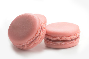 Magaroons on white surface leaning on one another