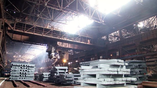 Work tick-borne crane and heating wells at the metallurgical plant. Metallurgical ingots. Ingot pit craneю
