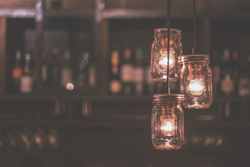 Vintage DIY light bulb in jars hanging at the bar night club