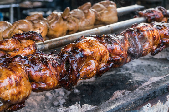 Grilled chickens in spinning rolls