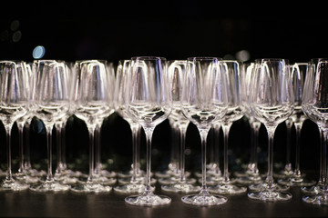 Transparent glasses on black shelf in luxury restaurant