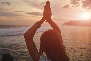 Fototapeta na wymiar Young woman practicing yoga - meditation on the beach.