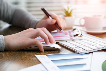 Women's hands with items for business on the table