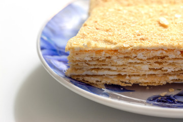 Napoleon cake on on a blue plate close-up