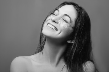 Young woman beauty. Perfect fresh skin. Toothy smile. Cheek dimples. Black and white portrait.