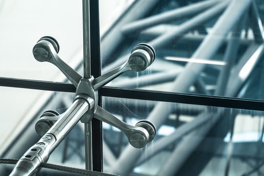 Architecture abstract background. Glass curtain walls. Metal fasteners elements of spider glass system. Facade detail Windows
