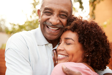 Senior black man and his middle aged daughter embracing, close up - Powered by Adobe