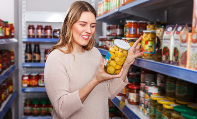 Woman choosing pickle goods
