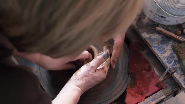 master class in pottery. potter's wheel and hands