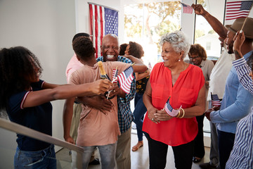 Three generation black family celebrating Independence Day at home together,close up