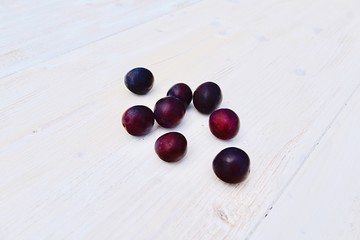 plums on wooden table