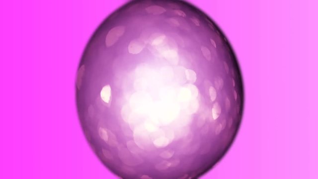 Lilac animated Easter egg on a purple background. Bright easter background. Colorful paschal backdrop with twinkling particles.