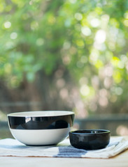 Black and white bowls on napkin on table