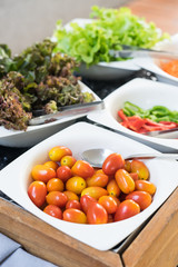 cherry tomatoes in a white bowl at the salad bar, healthy meal