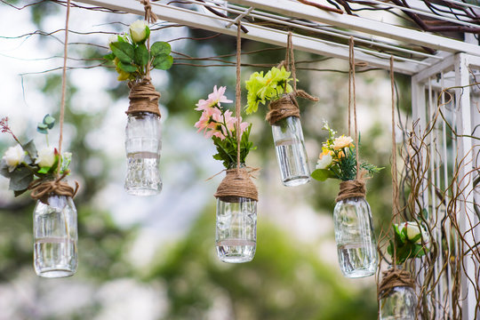 DIY old empty bottles can be used for event decoration as a flowers vases hand from bars