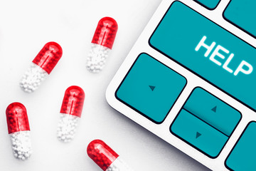 Many pills and computer keyboard