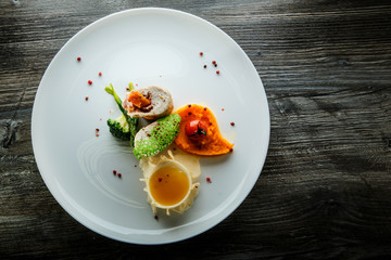 top view dissected stuffed chicken with pumpkin puree and yellow sauce