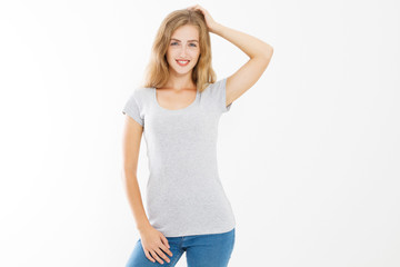 Young blonde woman with fit slim body in blank template t shirt and jeans isolated on white...