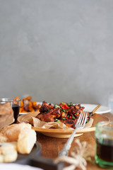 Low angle view of table served with traditional British Sunday roast dinner, featuring roasted chicken, squash and sweet potatoes