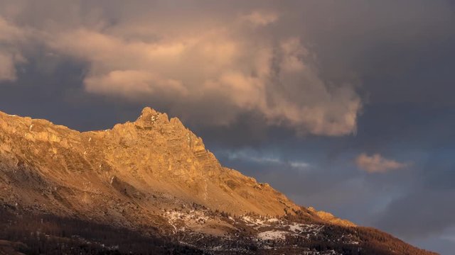 Sunset on Aiguilles de Chabrieres (Chabrieres Needles) with passing clouds in winter. Time-lapse. Ecrins National Park, Hautes-Alpes, European Alps, France