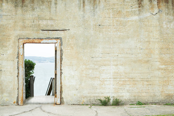 Cement wall with gate fold showing sea view