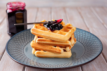 Waffles with blackcurrant jam.