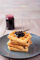 Waffles with blackcurrant jam.