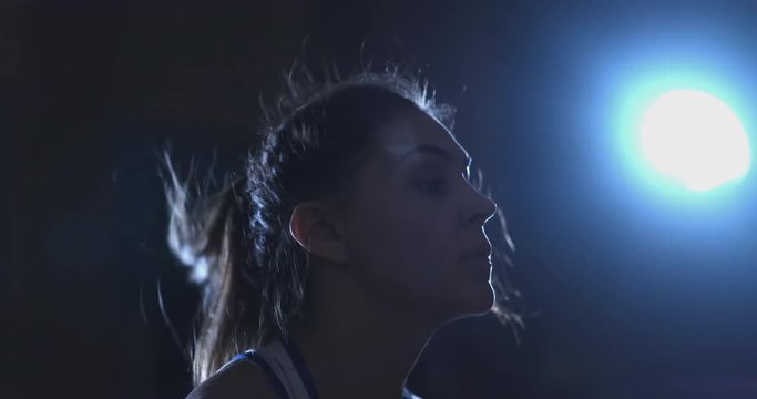 Close-up of the face of a Beautiful female boxer jumping on a rope during an active Boxing workout