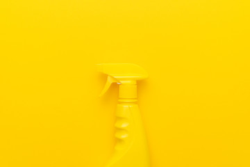 yellow cleaning spray on the yellow background with copy space
