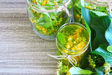 Leaves and flowers of linden. Fresh herbal lime tea. Linden flowers. Preparation of lime flowers for tea. Harvesting of linden blossom tea. 