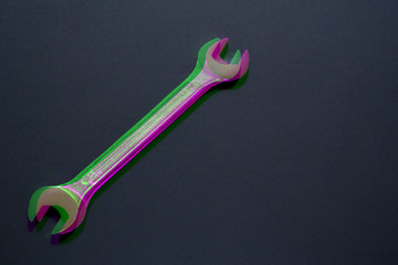 Spanner wrench on black background, Open box wrench chrome engineering instrument. Digital signal  glitch effect (rgb shift, slices). Screen error