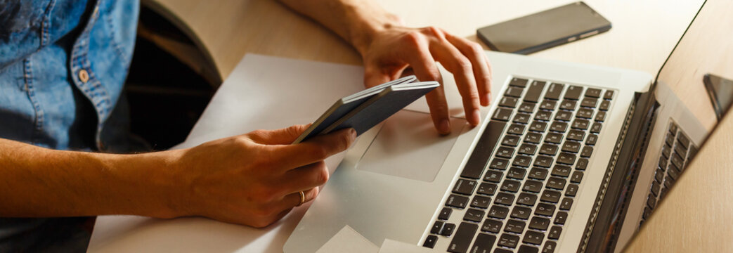 Young man sitting at table with laptop