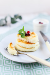 Homemade cheese pancakes on a white plate