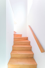 Fototapeta na wymiar Wooden stair in white stairway, minimal style