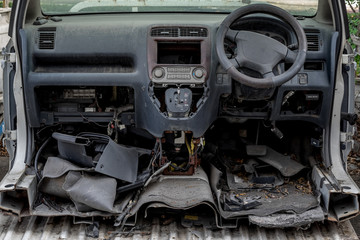 Fototapeta premium wrecked car front covered in dust cut in half