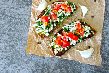 Toast with white cheese, herbs and garlic. Toasts of rye bread with white cheese and garlic. 