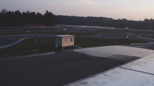 The drone flies above the racetrack.