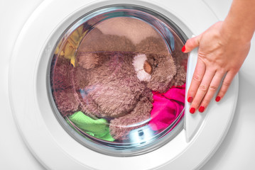 Washing machine and teddy bear.