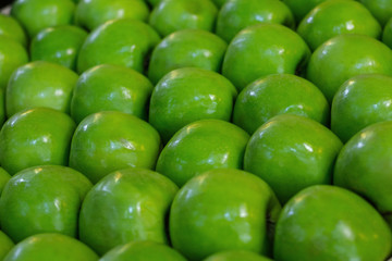 Green apples neatly laid out on the counter