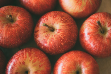 Red fresh apples as background. Close up view of heap of delicious apples as texture and background. 