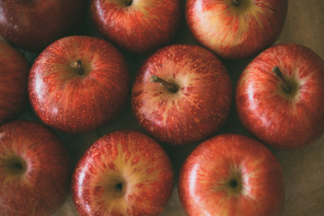 Red fresh apples as background. Close up view of heap of delicious apples as texture and background. 
