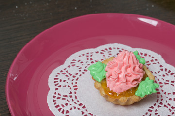 Basket cake decorated with cream of different colors. Stuffing from jam.