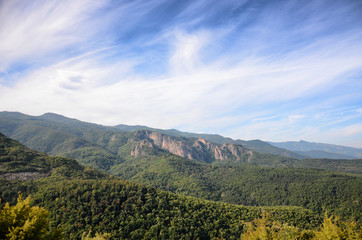 Fototapeta premium Spring time panoramic landscape from Rhodope mountain, Bulgaria. Blue sky with white clouds