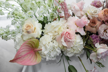 Event white restaurant table served and decorated with delicate fresh flowers