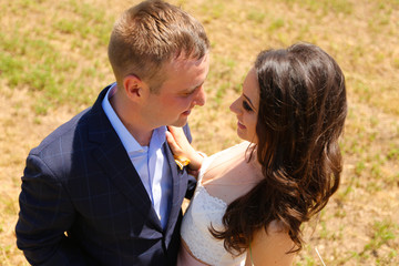 Beautiful engagement couple posing near hay