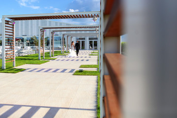 Wedding couple walking to the reception room