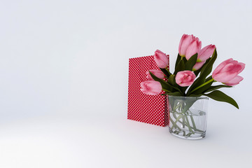 A bouquet of flowers  on a white background with a gift. 3D render.