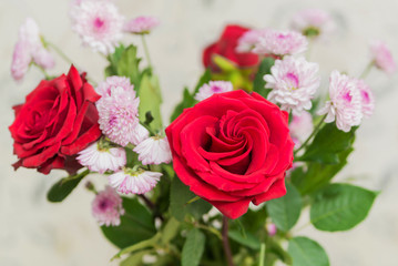 Fototapeta premium bouquet of flowers red roses and asters