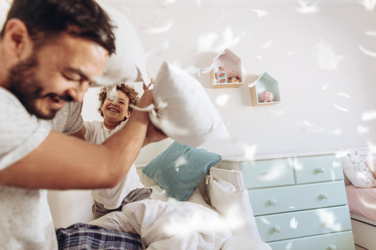 Father And Son Having A Pillow Fight